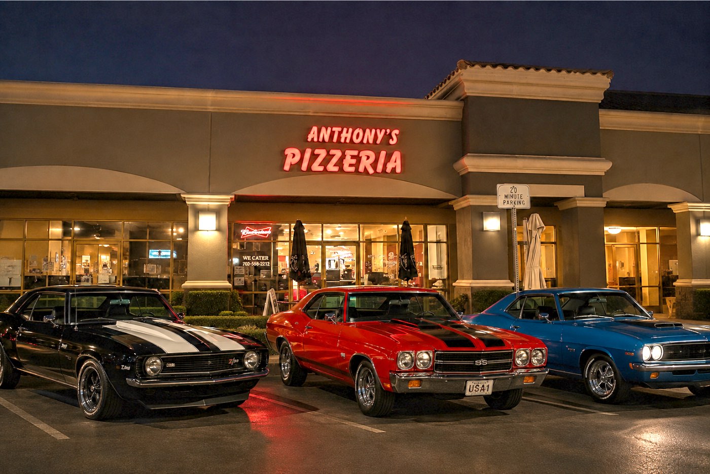 Anthony's Pizzeria at night, the red neon sign lit above the entrance, with classic muscle cars parked out front